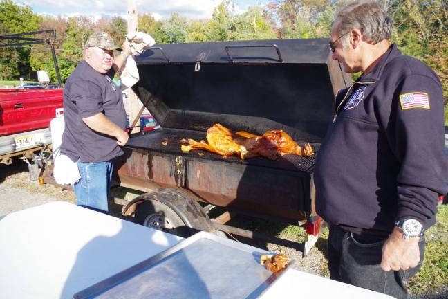 McAfee FD hosts 3rd annual pig roast Firefighters and Vernon residents Larry Predmore of Predmore Farms and Bob Winter worked at the grill for the McAfee Fire Department’s Third Annual Pig Roast.