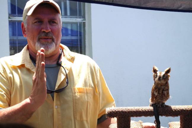 Avian Wildlife Center volunteer Dan Graham of Wantage is shown teaching Wallkill Wildlife Refuge visitors all about &#xec;Otis,&#xee; an Eastern Screech Owl. Otis was one of numerous birds, including a Red Tailed Hawk, that were on hand for families to enjoy.
