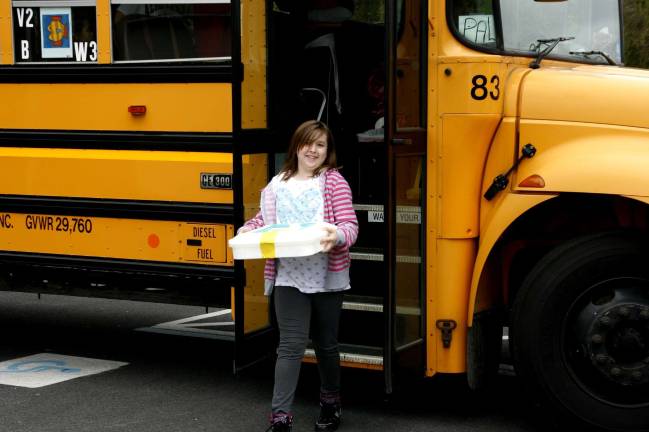 Poetry al fresco Ashley Bray steps off the bus, clutching celebratory cupcakes for after.