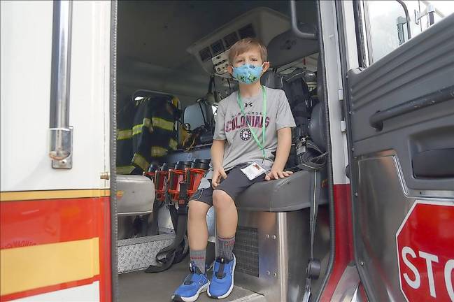 Graham sits in the firetruck (Photo by Vera Olinski)