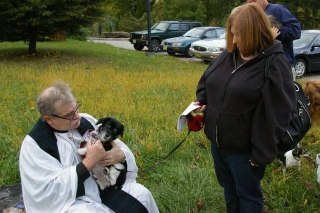 Winston, a 14-year-old &#x201c;Pomapoo&#x201d; owned by Jo Ann Fisher of Vernon is blessed by the Rev. Dr. Howard W. Whitaker of St. Thomas&#x2019; Episcopal Church.