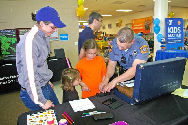 Healthy kids are an achievable goal Hardyston Township Police Department Patrolman Mike Petershack spent much of the day fingerprinting children during the YMCAþÄôs Healthy Kids Day. The fingerprint sheets were given to the parents for safekeeping in the event an emergency might arise.