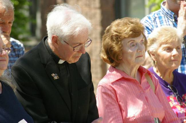 Monsignor Robert Carroll of Our Lady of Fatima Church in Highland Lakes and Vernon resident Shirley Baldwin listen as prayers are offered.