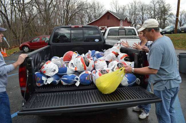 Labor Commissioner Harold J. Wirths, right, was joined by his wife, Debbie, in unloading 150 Thanksgiving turkeys for distribution to needy families through the Sussex Help Center.