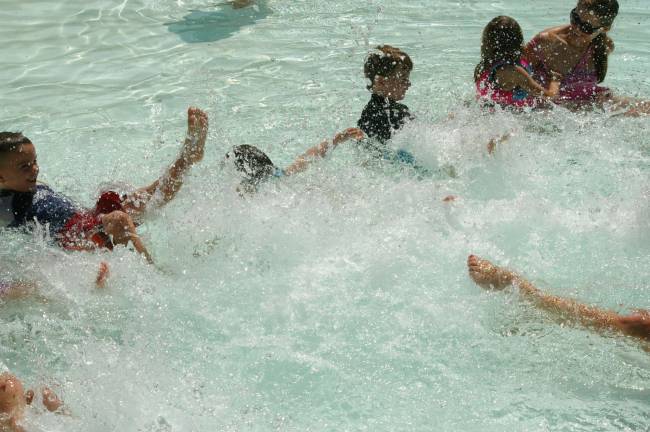 Kids practice their kicking skills in the Hightide Wavepool at Action Park.