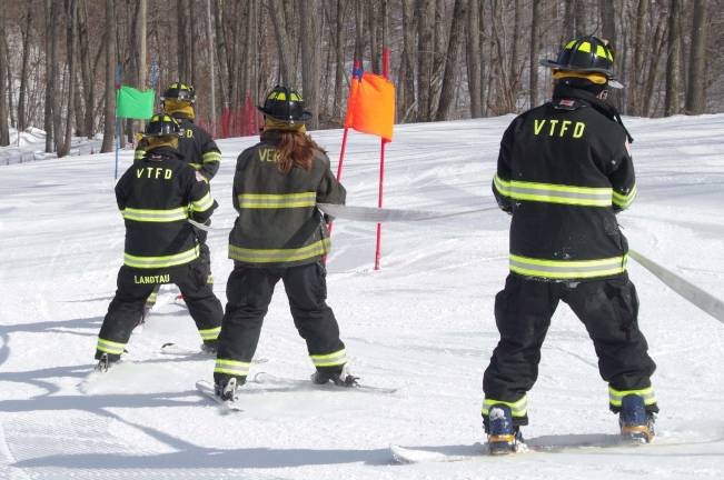 Firefighters race for burn center Members of the Vernon Township Fire Department are shown headed toward the first gate on the slalom course.