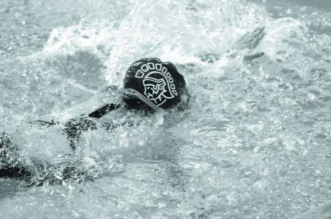 Area schools take part in swim meet The Sparta Spartan emblem emblazons the cap of a Sparta High School female swimmer.