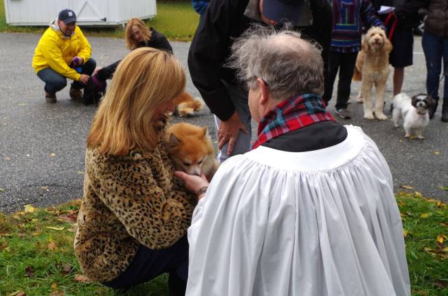 Dog owners and their pets wait to be blessed at the St. Thomas&#xfe;&#xc4;&#xf4; Episcopal Church Blessing of the Animals service.