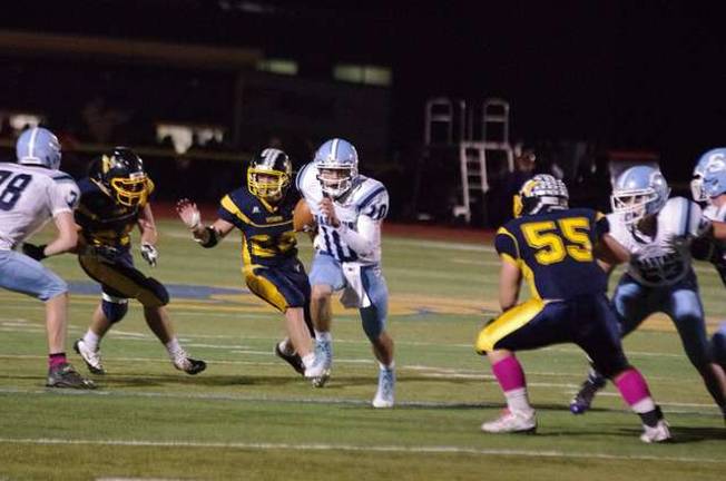 Sparta quarterback Anthony Argula (10) runs through a hole on a keeper. Argula threw for 264 yards and four touchdowns.