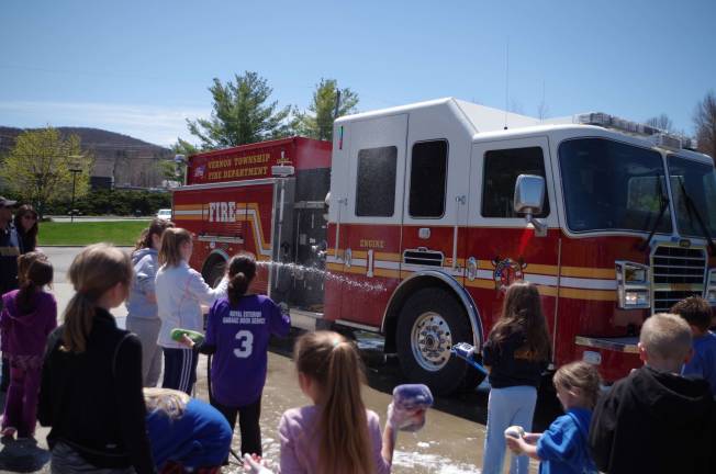 Engine 1 of the Vernon Township Fire Department gets washed at the fundraising car wash held by the Vernon Girls Softball League.