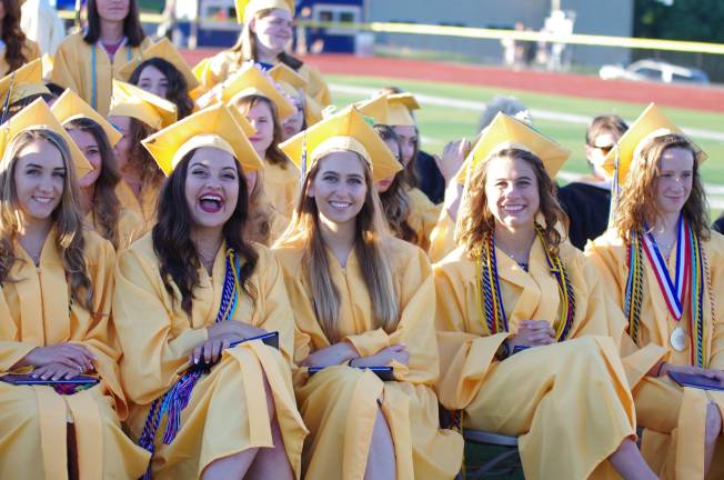 Graduates are all smiles during graduation ceremony.