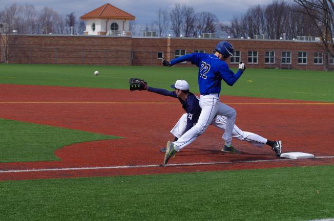 Pope John's first baseman Matt Piwko stretches for the catch as Northern Valley's Anthony LoFaro sprints towards the base. Pope John XXIII High School beat Northern Valley Regional High School (Demarest, N.J.) in boys varsity baseball on Saturday, April 5, 2014. The final score was 6-1. The game was played at Pope John XXIII High School in Sparta Township, New Jersey.