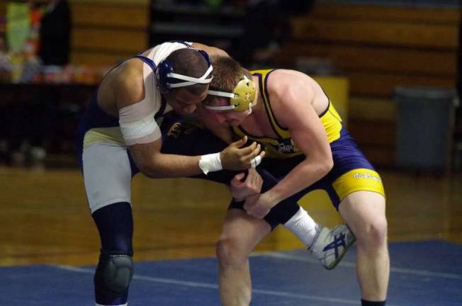 Pope John wrestlers defeat Vernon At left, Pope John's heavily bandaged Deriam Guridy didn't let pain stop him in his victory against Vernon's Pat Thompson in the 182 pounds weight class.
