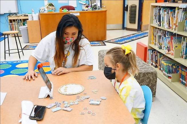 Kindergarten teacher Ivory Petti with a student (Photo by Vera Olinski)