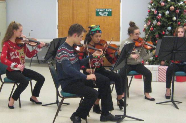 PHOTOS BY JANET REDYKEThe left section of the Vernon Township High School Chamber Orchestra tunes up before their concert for the Vernon Woman&#x2019;s Club.