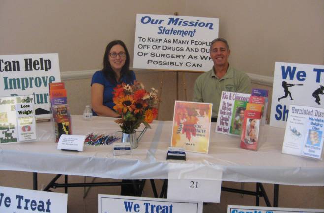 Michelle Thienel and Dr. Peter Karas answer chiropractic questions at the fair.