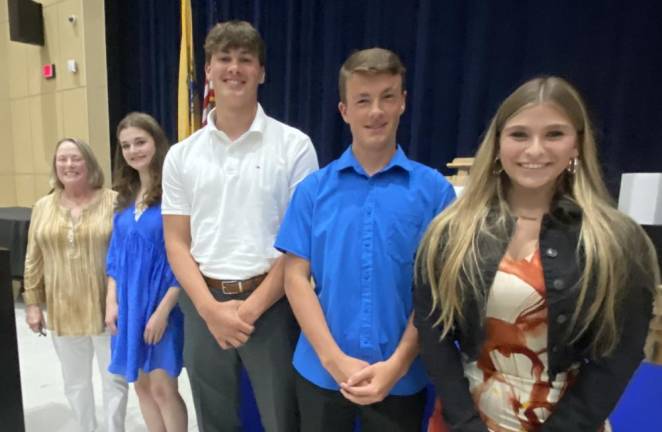 Valerie Seufert, education committee chairwoman of the Vernon Township Woman’s Club, presents scholarships to, from left, Cara Davies, Robert Nathan, Luke Keating and Gabrielle Miller, all recent graduates of Vernon Township High School.