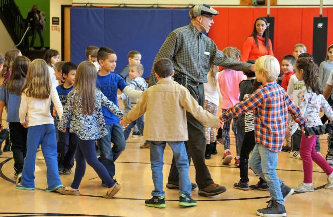 In center and right, music teacher Michael Moschella and Phys. Ed. teacher Michele Gonnelli lead students through &quot;Apple Tree.&quot;
