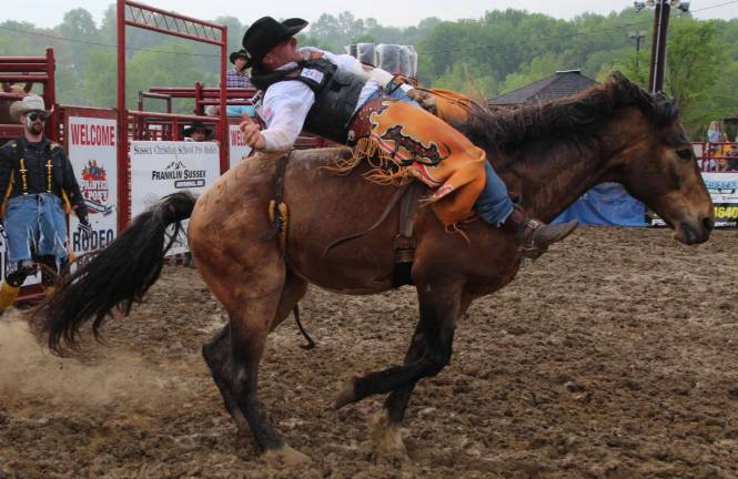 Rain doesn't damper Sussex Christian Rodeo J.R. Mills of Okemos, Mich., is shown bareback riding.