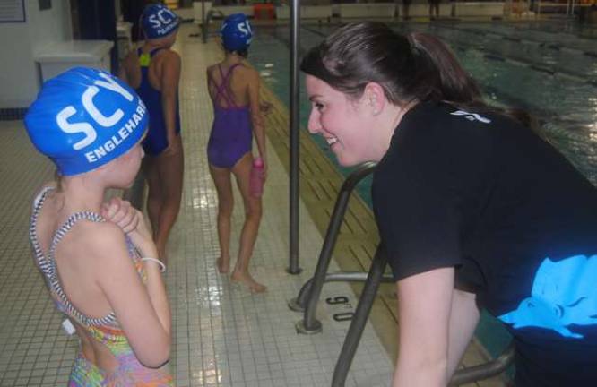 New Sussex County YMCA Aquatic Director Sarah Navarro, right, talks to a swimmer.