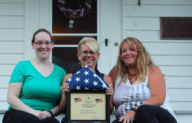 Laura Franek, Vice Regent; Lisaann Permunian, Committee Chairman; Ashley Ziccardi, Regent are shown with the American flag which was flown over the US Capitol on July 4, 2016. (Image provided.)