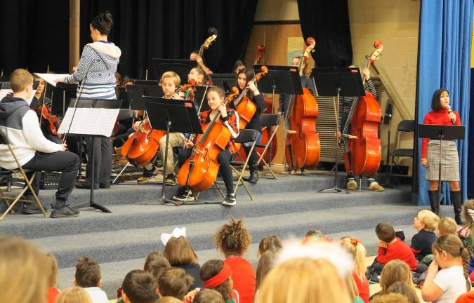 The Glen Meadow Orchestra plays &quot;Twas the Night Before Christmas&quot; with Principal Rosemary Gebhardt, on right.