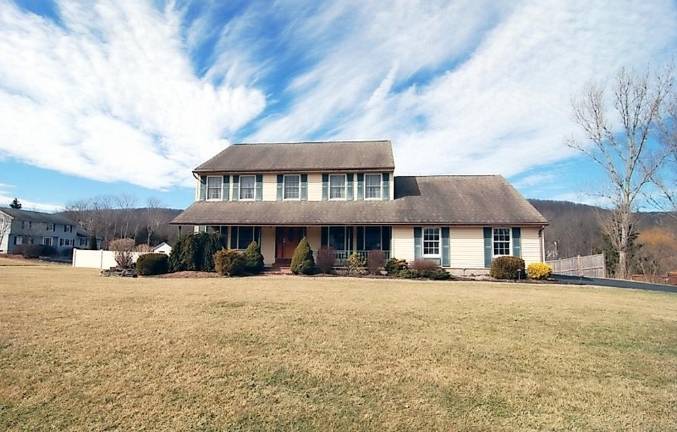 Spacious center hall colonial has in-ground pool