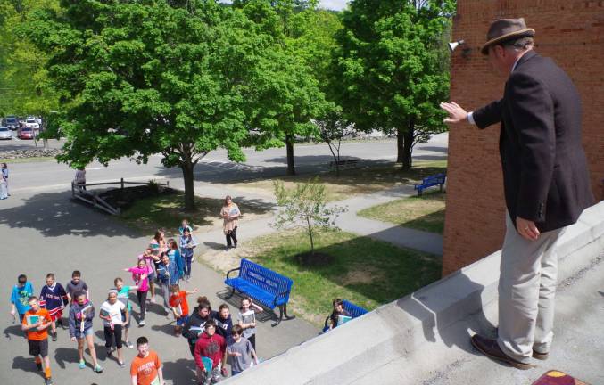 Lounsberry Hollow Middle School Principal Charles McKay waves to the students below.