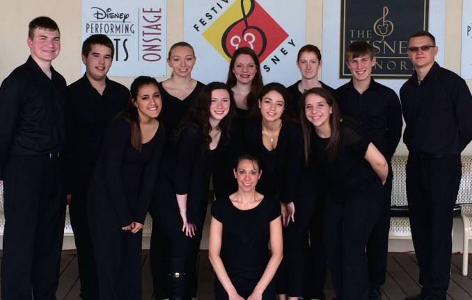 The Vernon Township High School orchestra is shown in Disney World. Orchestra Director Jennifer Krott is shown in the front center.