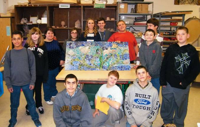 Photos by Viktoria-Leigh Wagner Visual-Fine Arts teacher Kelly Kuzicki, center, surrounded by her class of Exploratory MCI Art students presenting their first completed mural, 'A Field of Peace Poppies,' which will be hung in the English Dept. at High Point Regional High School.