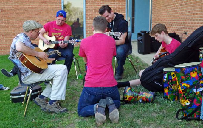 A guitar and percussion jam was one of many art offering that evening. At the left, playing guitar is Walnut Ridge music teacher Michael Moschella.