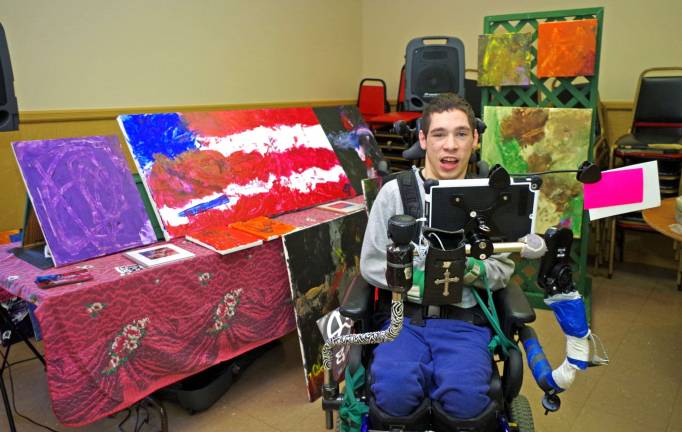 Barry Lakes artist Nick Cerrato, a junior at Vernon Township High School, is shown in front of his work for sale at the Vernon VFW.