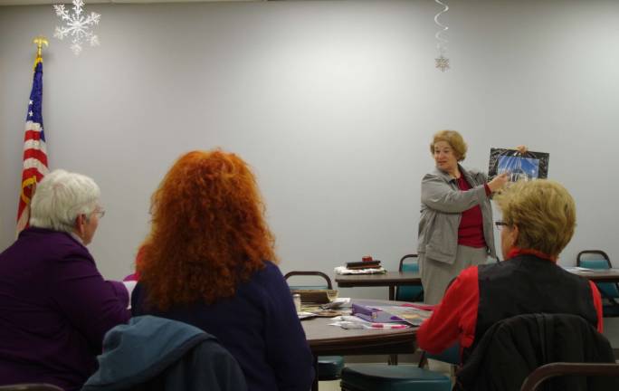 Photographer shares her knowledge during presentation Vernon Camera Club members discuss their photographs during the latter portion of the meeting. Each month there is a different photo assignment to share with the club’s membership.