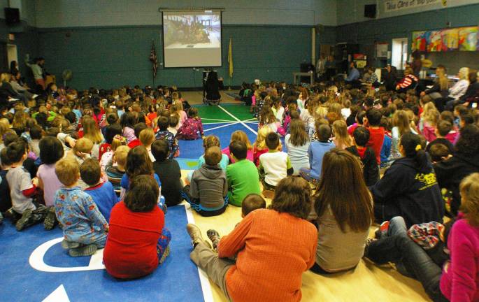 Walnut Ridge students honor Wantage artist Students watching the video about Wantage-based illustrator and artist Art Frisbie.