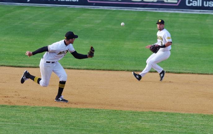 Sussex infielder Steve Nyisztor looks back after bobbling the ball which then flies into the air towards teammate Jarred Mederos in the first inning.