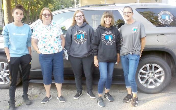 After tumult, the Heims are no longer humane society officers Selina McGinnis (far left) and Janet Heim (second from left) stood outside borough hall with Hound Hunters of Pennsylvania, which finds lost animals and do their best to return them to their owners. (Photo by Frances Ruth Harris)