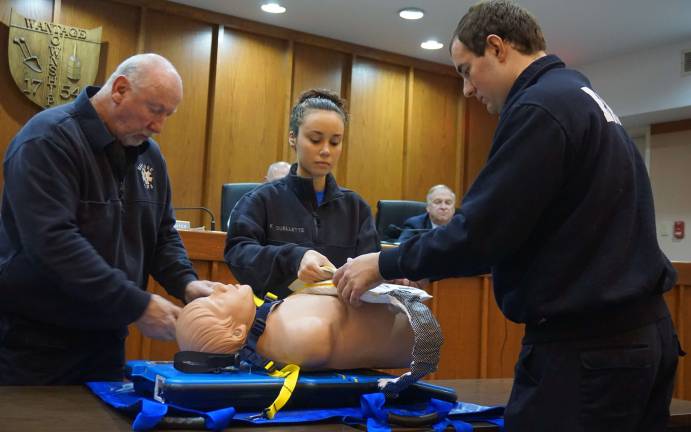 PHOTOS BY VERA OLINSKI From left, Wantage Township First Aid Squad President Bill DeBoer, Training Officer Kayla Ouellette and Captain Joe Martin demonstrate the new AutoPulse System for the Wantage Township Committee.