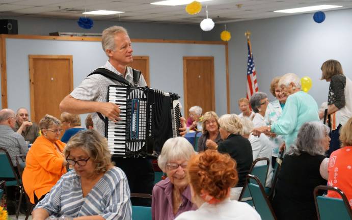 PHOTOS BY VERA OLINSKISeniors enjoy the Vernon Senior Center 25th Anniversary as Eric Kerssen plays the accordion.