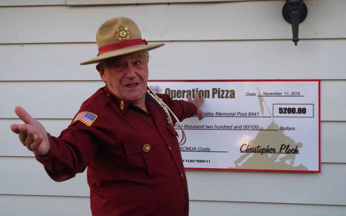 ‘Operation Pizza’ comes to fruition Post Commander Jim Davis asks his fellow veterans about whether the symbolic check would be suitable to mount near the VFWþÄôs front door.