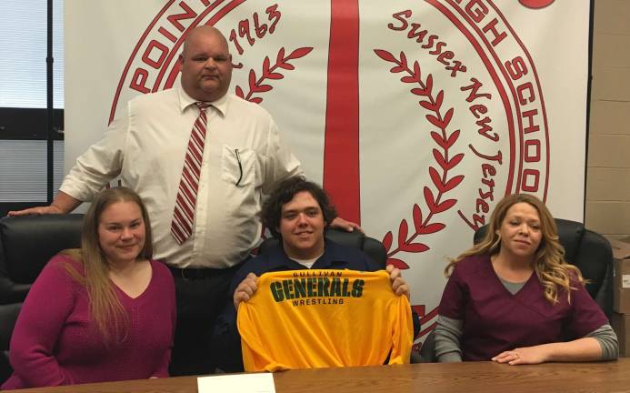 advancing wrestler High Point's Tom Hubmaster, seated center, signs his Letter of Intent to continue his wrestling career at SUNY Sullivan next season. Pictured seated are his step mother Jessica, left, and mother Angela Turnbell, right. Standing is Tom's father, Tom Hubmaster.