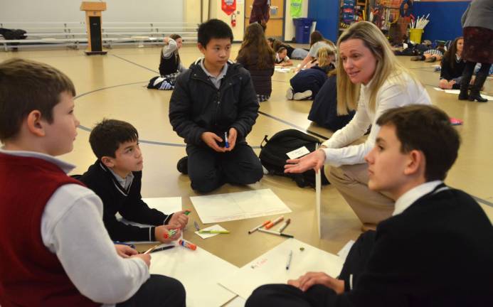 Linking Lions helps students bond Reverend George A. Brown Memorial School principal Patricia Klebez, second from right, talks to a group of Catholic Academy of Sussex County students about its vision board during a Linking Lions meeting in November at Reverend George A. Brown Memorial School in Sparta.