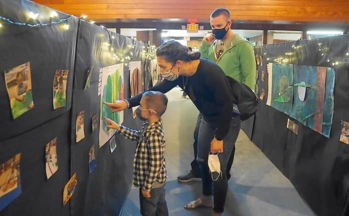 Parents admire their son’s artistry (Photo by Vera Olinski)