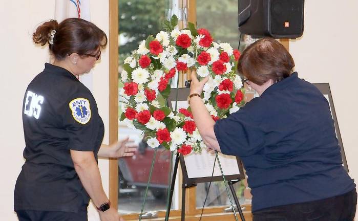 Sparta Ambulance Squad re-dedicates Memorial Garden to remember fallen members Miriam Ungar and Janice Johnson place a memorial wreath (Photo provided)