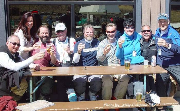 Toasting a great ski season on the deck of South Lodge: Bob Veit, waitress Teresa, Steve Boshart, Steve Kroeger, Jim Backman, Patrick Jalbert, Buffy Whiting, Tim Reid and John Whiting