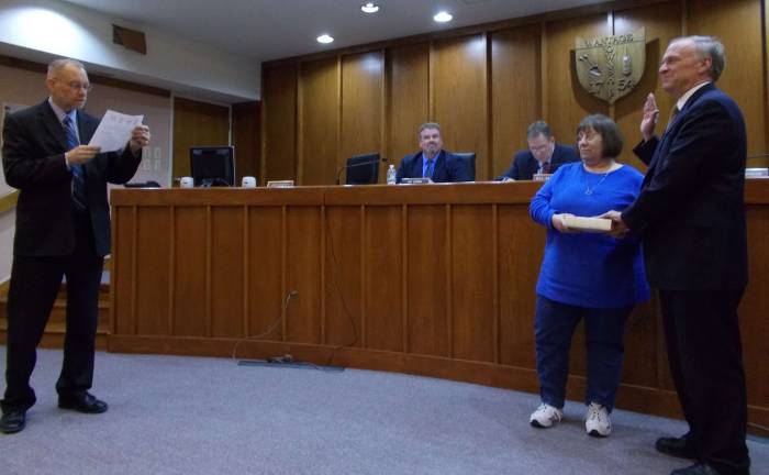 Township Administrator James Doherty administers the Oath of Allegience to Township Attorney Glenn Kienz.