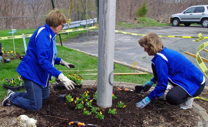 Vernon PAL employees Jeanne Buffalino and Cindy Rourke planted flowers around the flagpole.