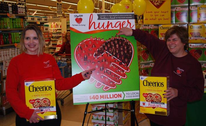 ShopRite workers honored as hunger-fighting heroes Daniela Pradarits (Columbia) and Tammy Wiley-Howell (Hamburg) point to themselves on the special edition Cheerios Box.