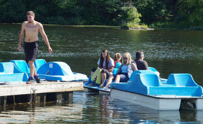 A family enjoys the warm air and a paddleboat rental last weekend on Wawayanda Lake.