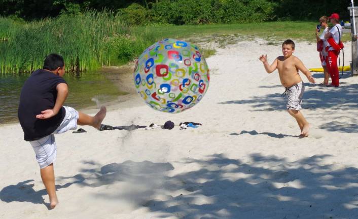 Ryan McElwee, 8, and Gage Vandunk, 10, played on the beach with an oversized inflatable beach ball.