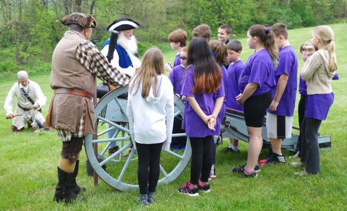 Colonial Day brings lessons and fun The children were able to ask questions about the cannon.